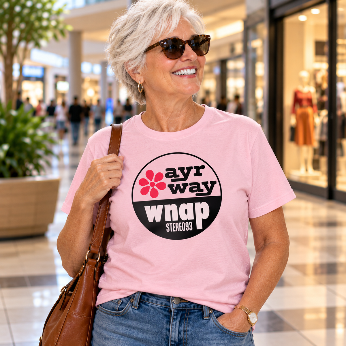 Woman wearing a pink Ayr-Way WNAP Stereo 93 Gildan 5000 T-shirt featuring vintage Indianapolis department store and radio station artwork.