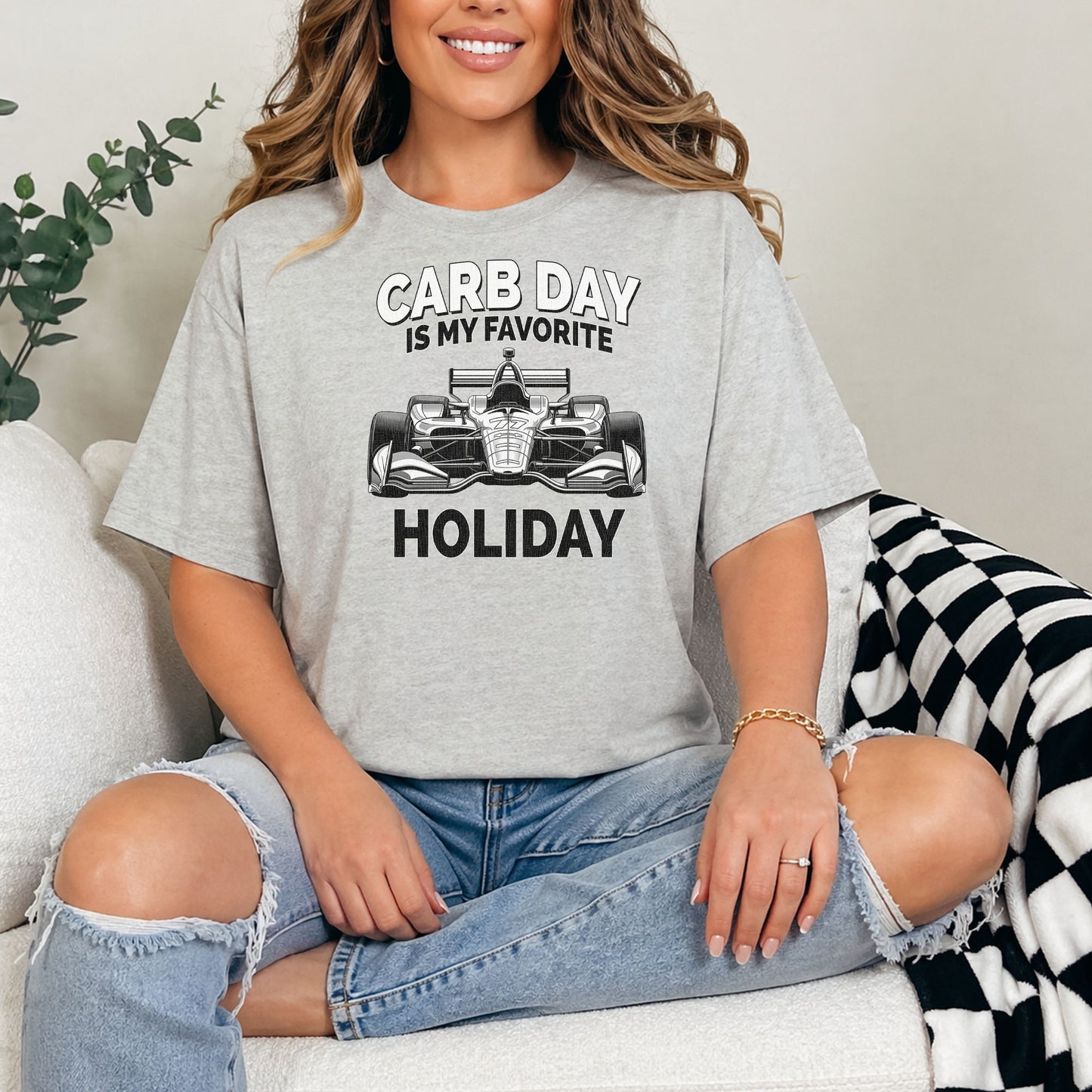 Close-up of person wearing Carb Day racing shirt featuring vintage style Indy car design