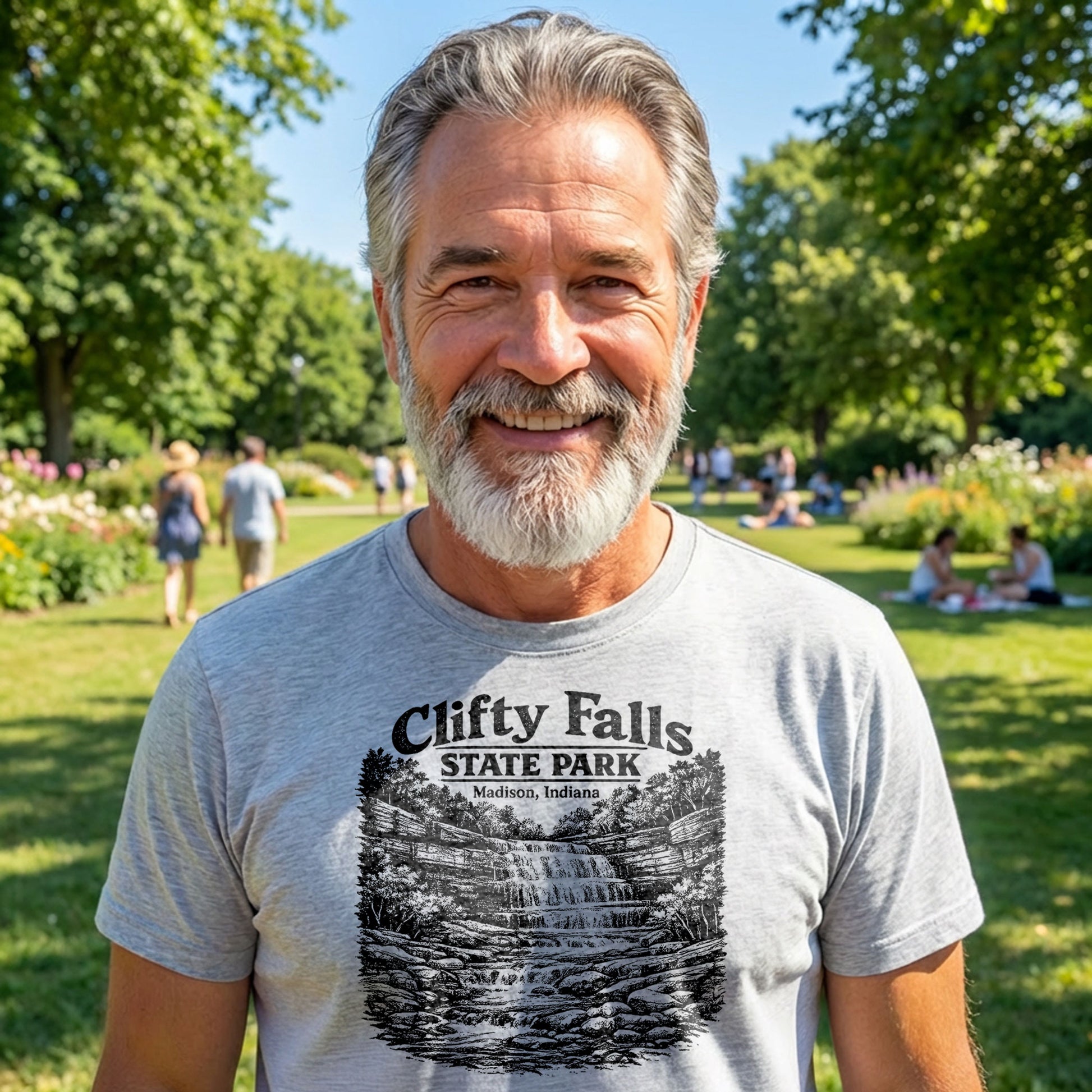 Smiling man wearing Clifty Falls State Park t-shirt standing in sunny park setting

2.