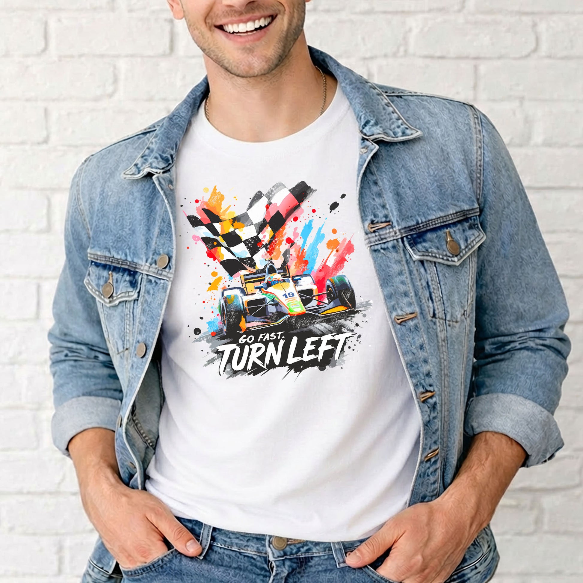 Male model showcasing motorsports graphic tee in front of white brick wall