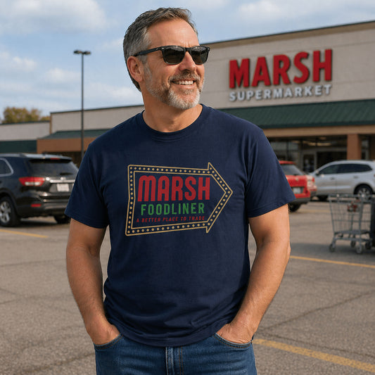 Middle-aged man wearing Marsh Foodliner shirt standing in grocery store parking lot