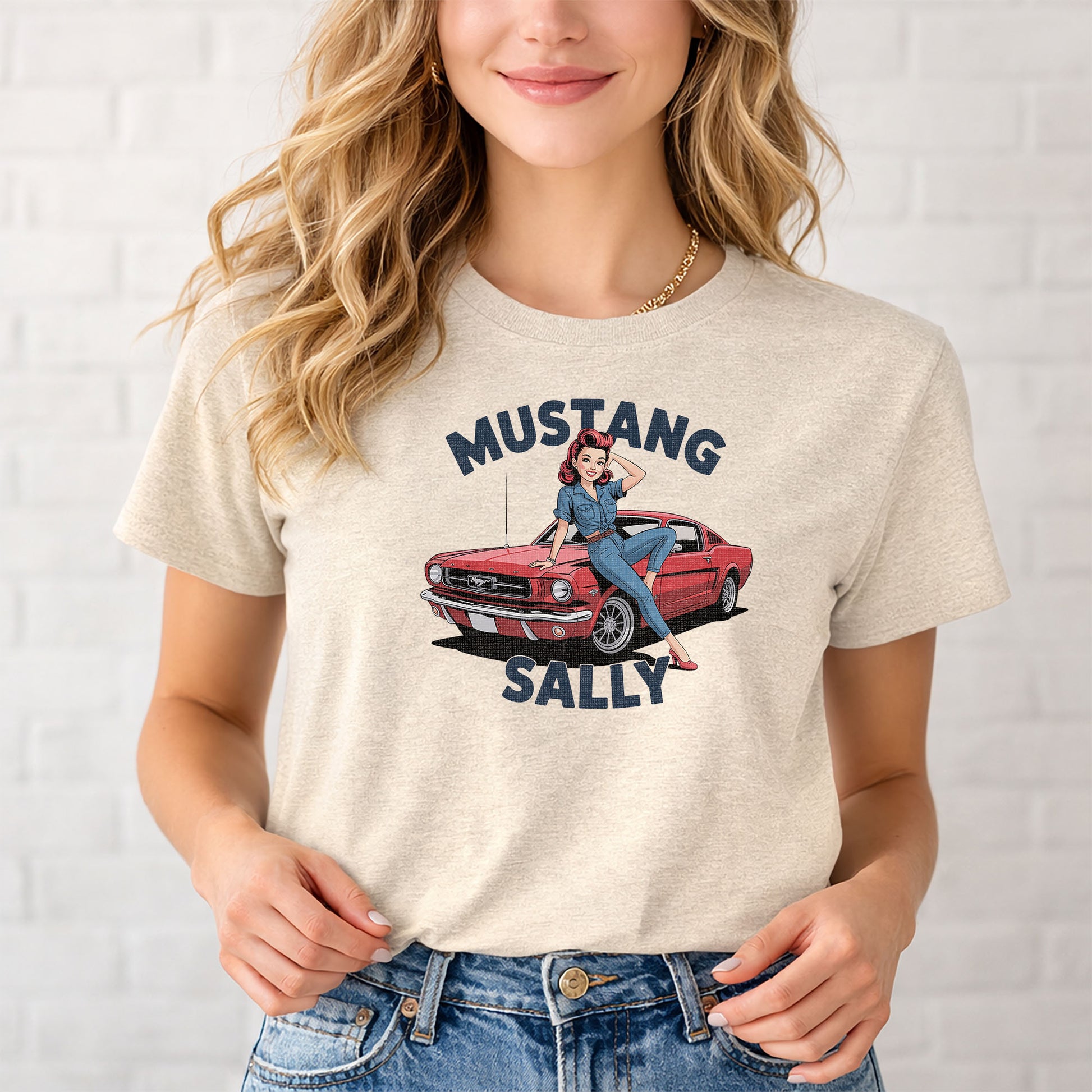 Female model wearing vintage car culture t-shirt with red Mustang graphic against white wall