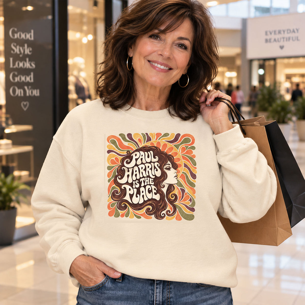 Woman wearing a cream Gildan 18000 sweatshirt featuring the vintage Paul Harris Is The Place Indiana design in a shopping mall.