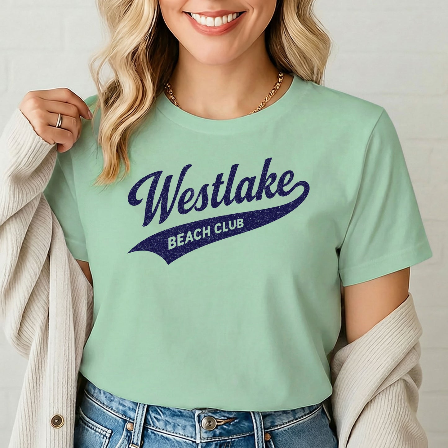 Female model wearing vintage beach club shirt against white brick background

4.
