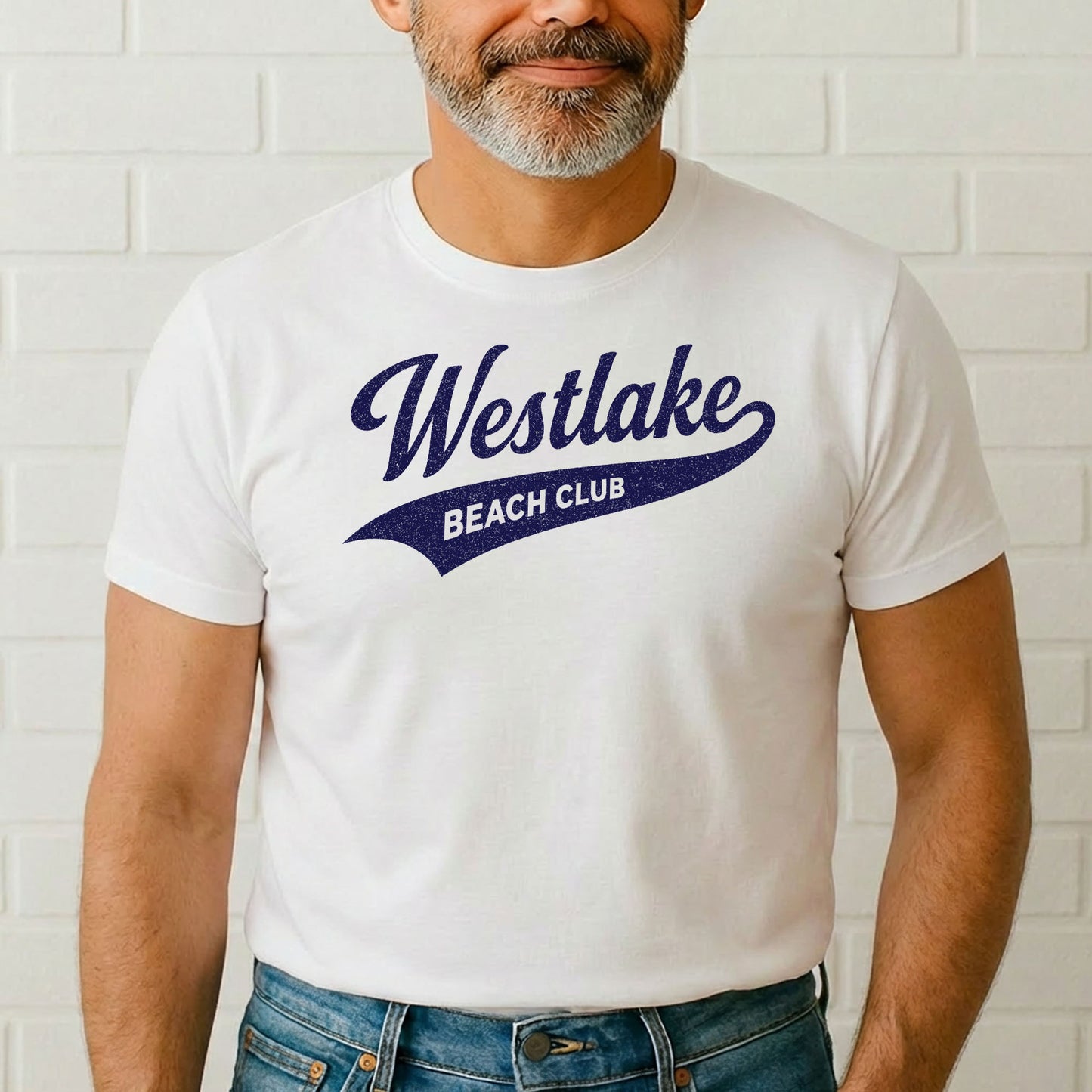 Male model wearing Westlake Beach Club t-shirt standing in front of white brick wall