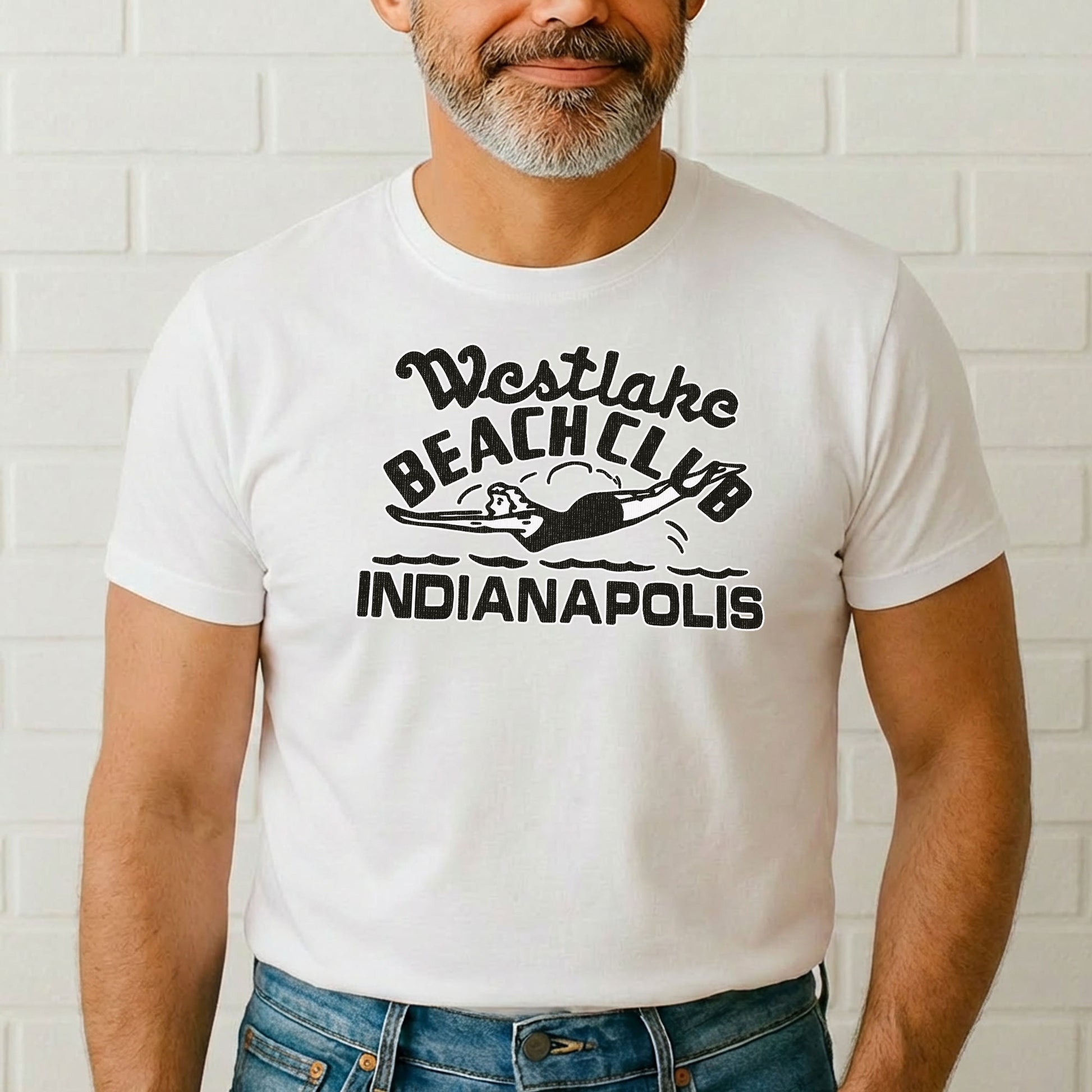 Male model wearing Westlake Beach Club t-shirt standing in front of white brick wall